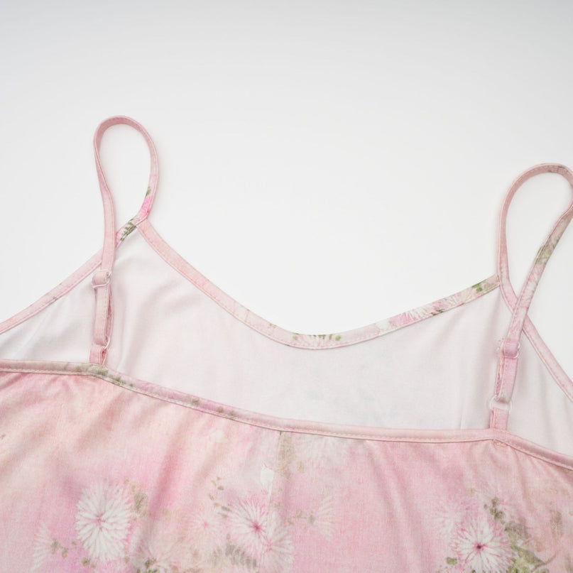 A pink midi dress with floral print and embellishments featuring a narcissus flower design