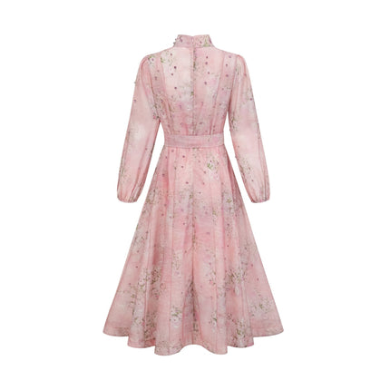 A pink midi dress with floral print and embellishments featuring a romantic Narcisse design