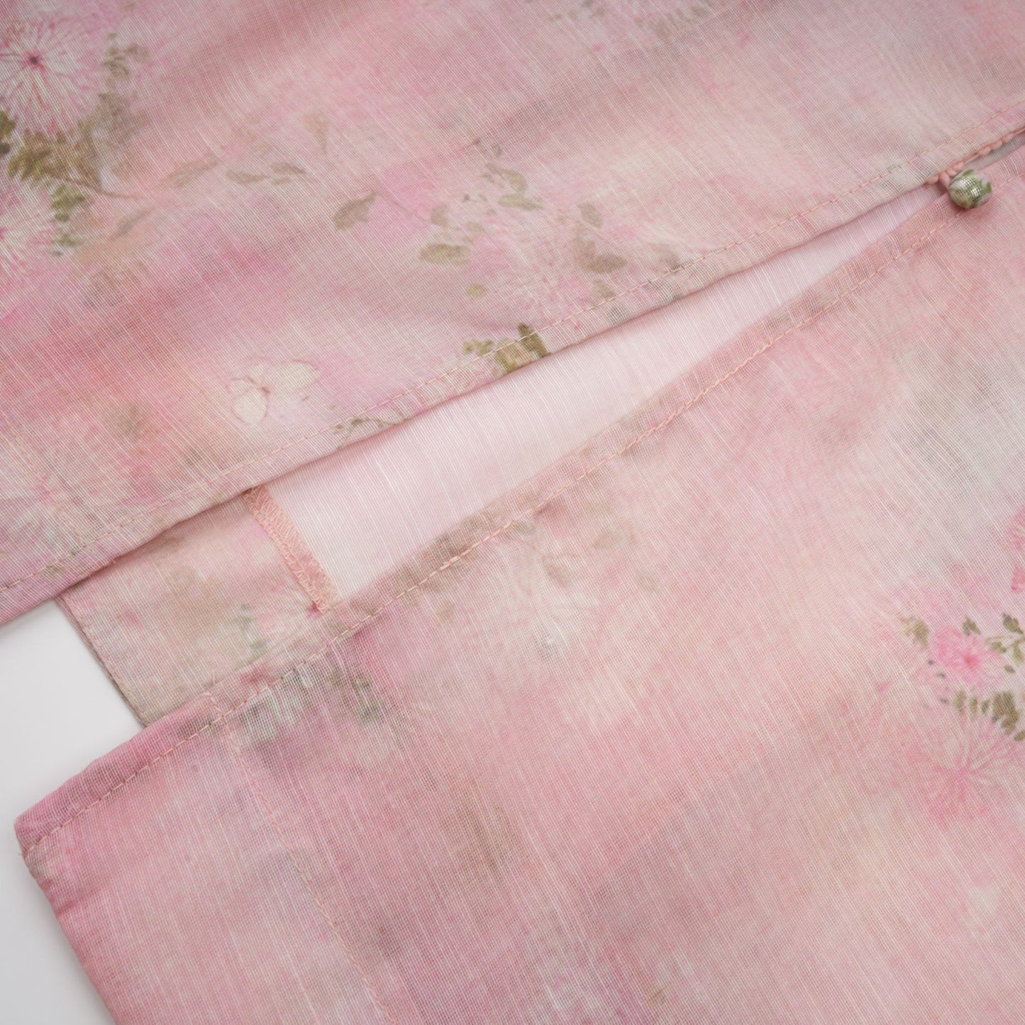 A pink midi dress with floral print pattern and embellished details featuring the Narcisse design