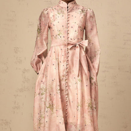 A pink midi dress with floral print pattern and embellishments featuring a design inspired by narcissus flowers