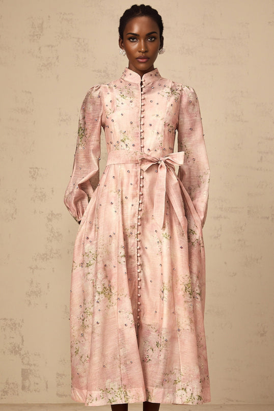 A pink midi dress with floral print pattern and embellishments featuring a design inspired by narcissus flowers