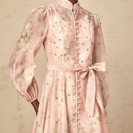 A pink midi dress with floral print pattern and embellishments featuring a design inspired by narcissus flowers