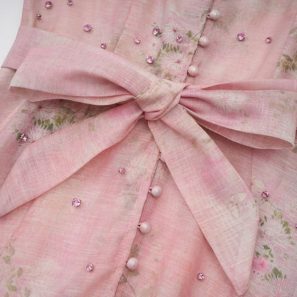 A pink midi dress with floral print pattern and embellishments named Narcisse