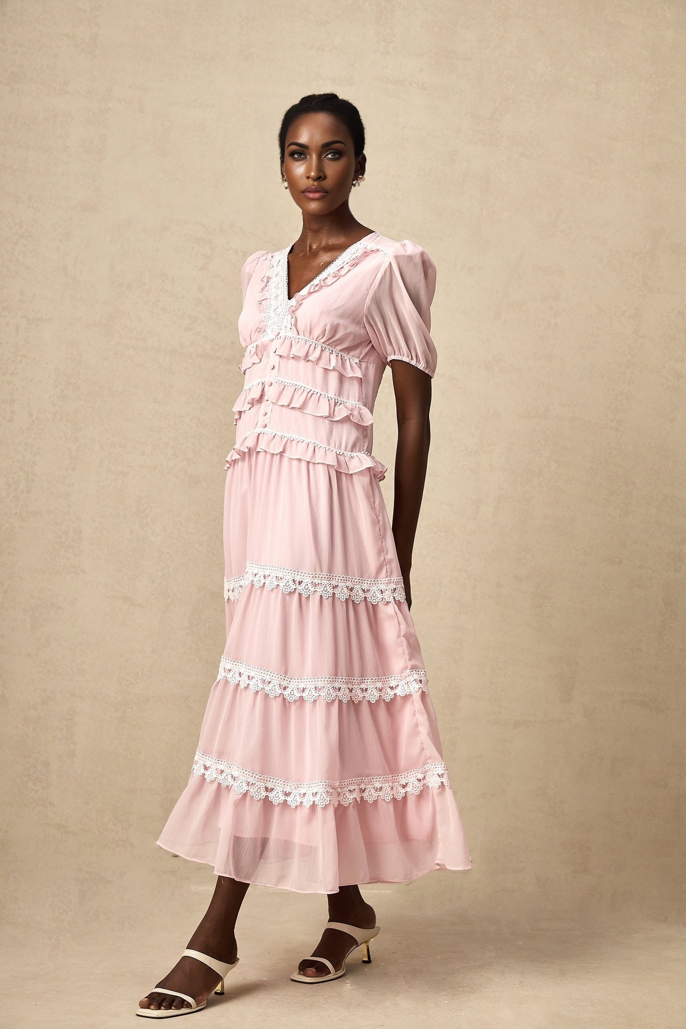 A pink midi dress with ruffled tiers and a feminine Amelie style
