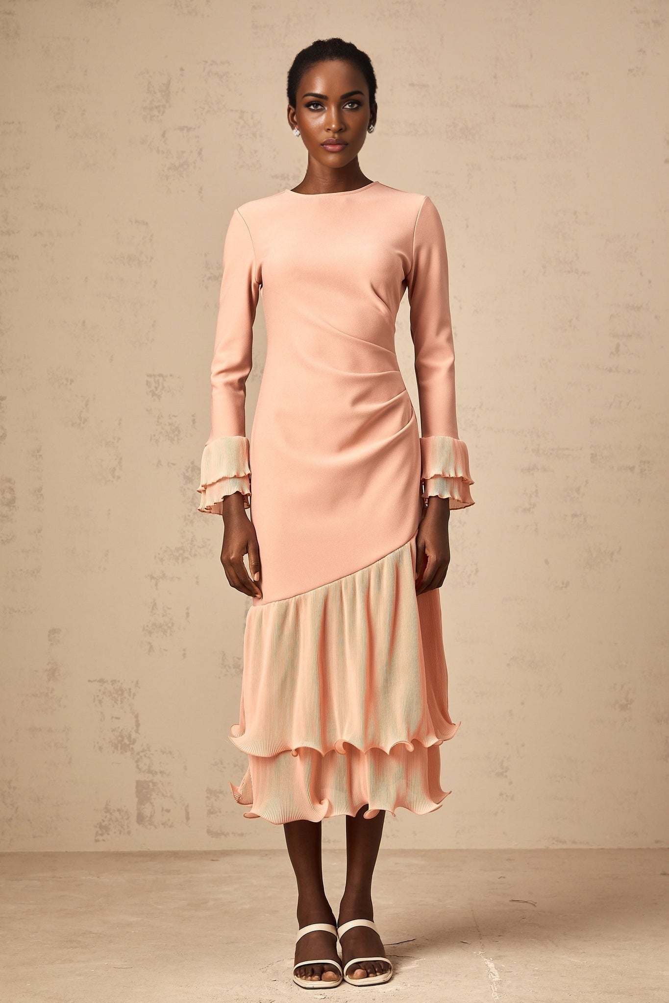 A pink midi dress with ruffled trim and paneled design featuring a feminine silhouette and delicate details