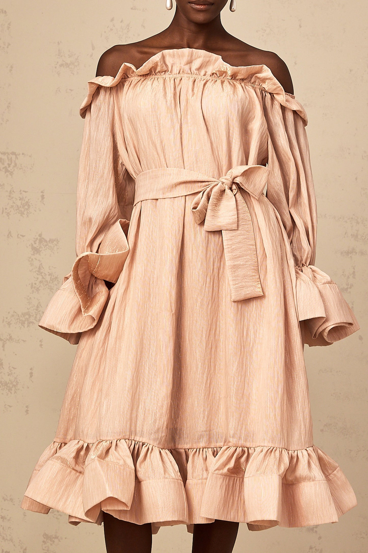 A pink midi dress with ruffles and a tied waist detail named Agathe