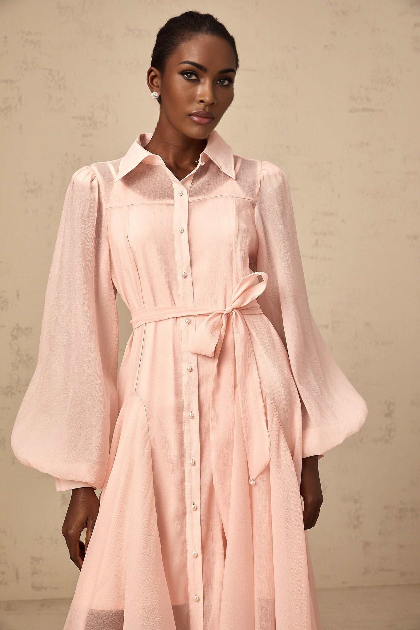 A pink midi shirt dress with a tied waist and long sleeves named Sibylle