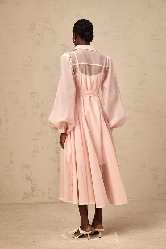 A pink midi shirt dress with a tied waist detail named Sibylle featuring long sleeves and a collar