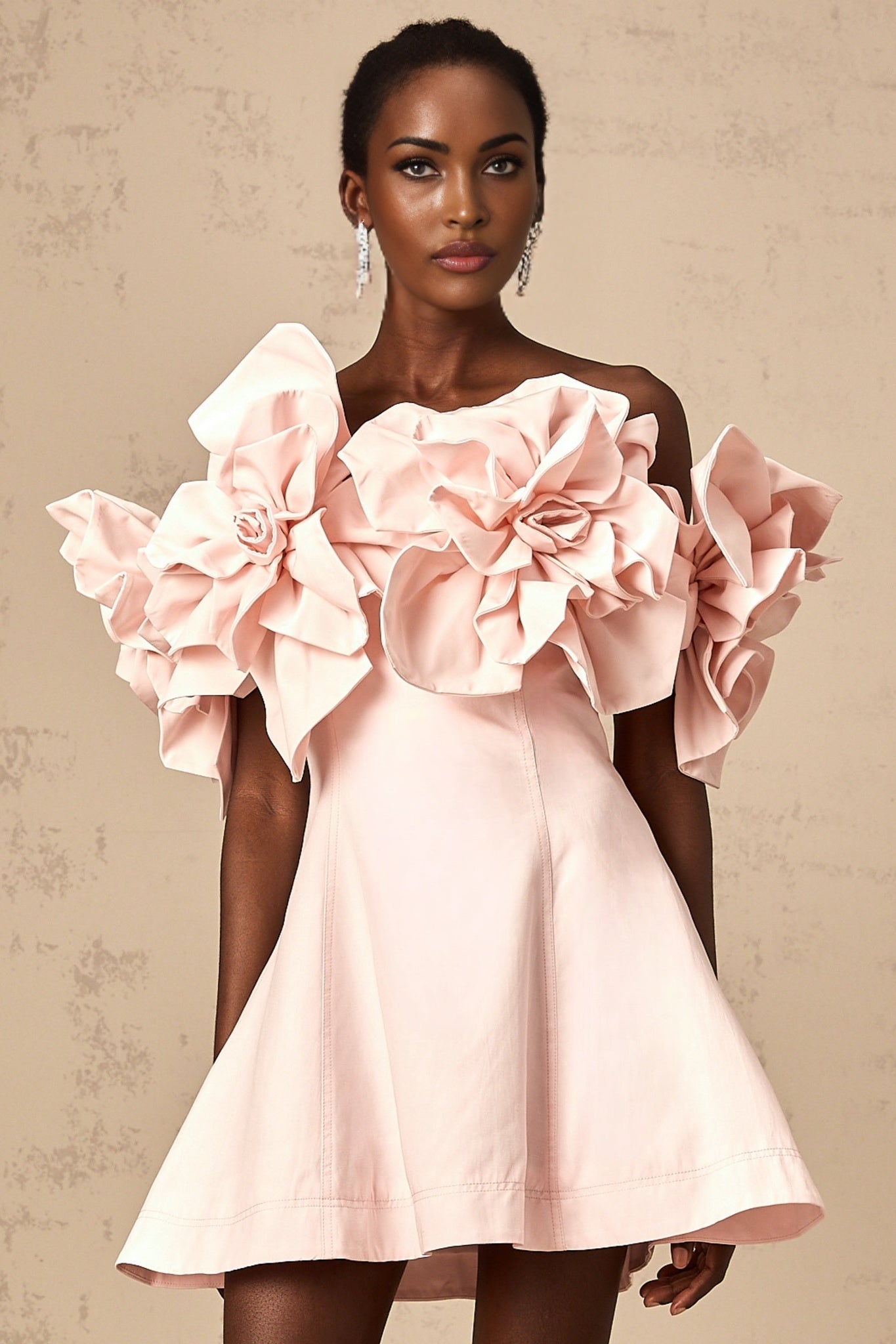 A pink mini dress with an offshoulder neckline featuring three dimensional floral petal details along the bodice named Juliette