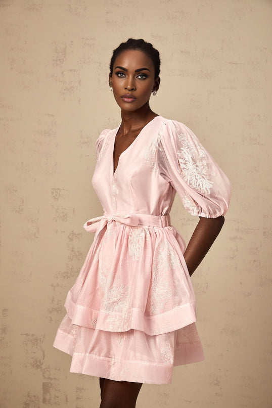A pink mini dress with floral embroidery and layered design called Florence