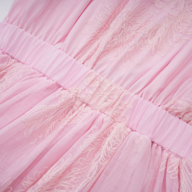 A pink mini dress with floral embroidery and layered skirt featuring a delicate Florence design