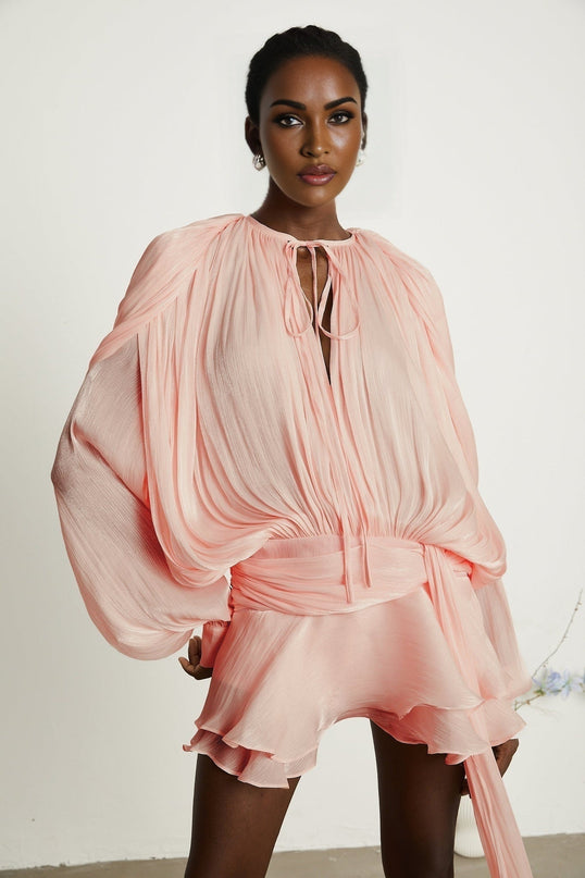 A pink mini dress with full pleats and ruffles named Eugenie