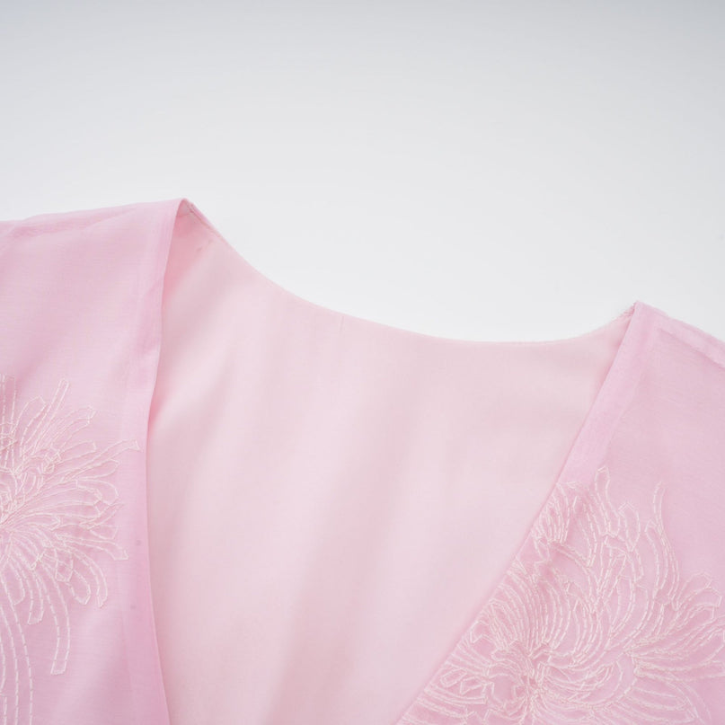 A pink mini dress with layered skirt and floral embroidery details called Florence