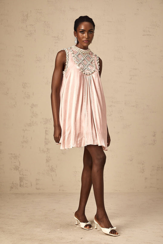 A pink mini dress with pleated skirt and embellished details named Helena