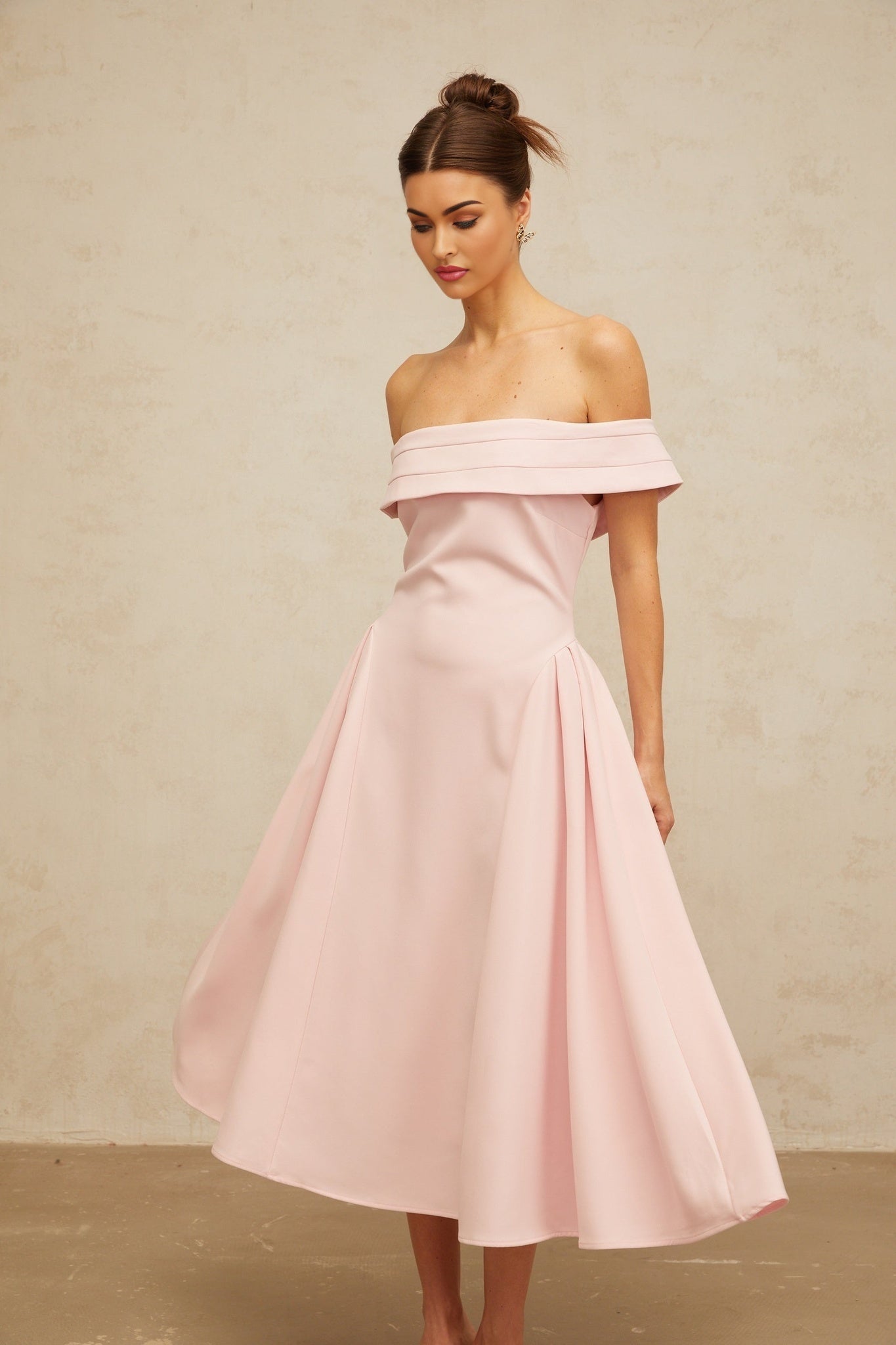 A pink off shoulder midi dress with pleated details and a flowy silhouette named Zelie
