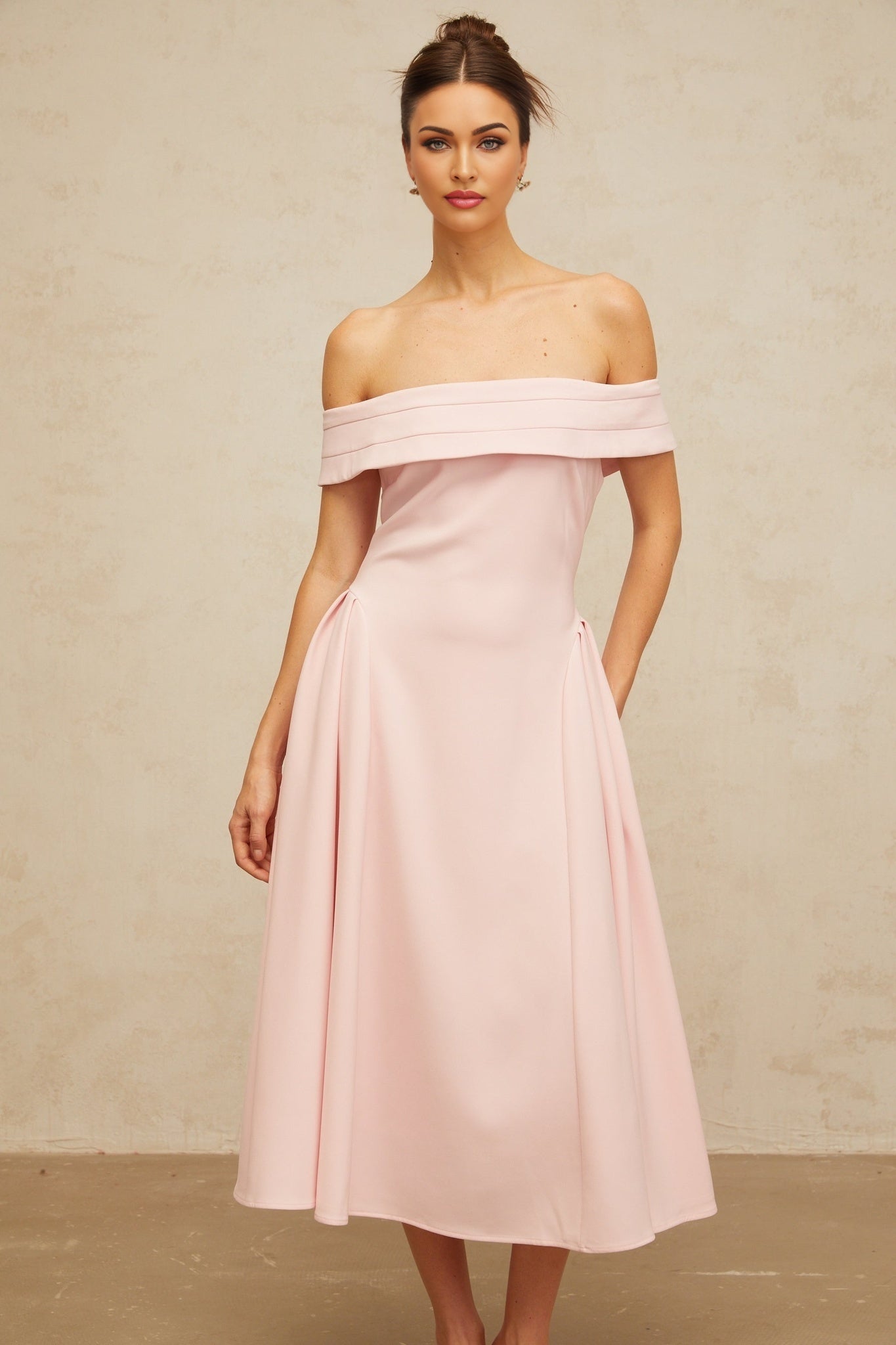 A pink off shoulder midi dress with pleated details and a flowy silhouette named Zelie