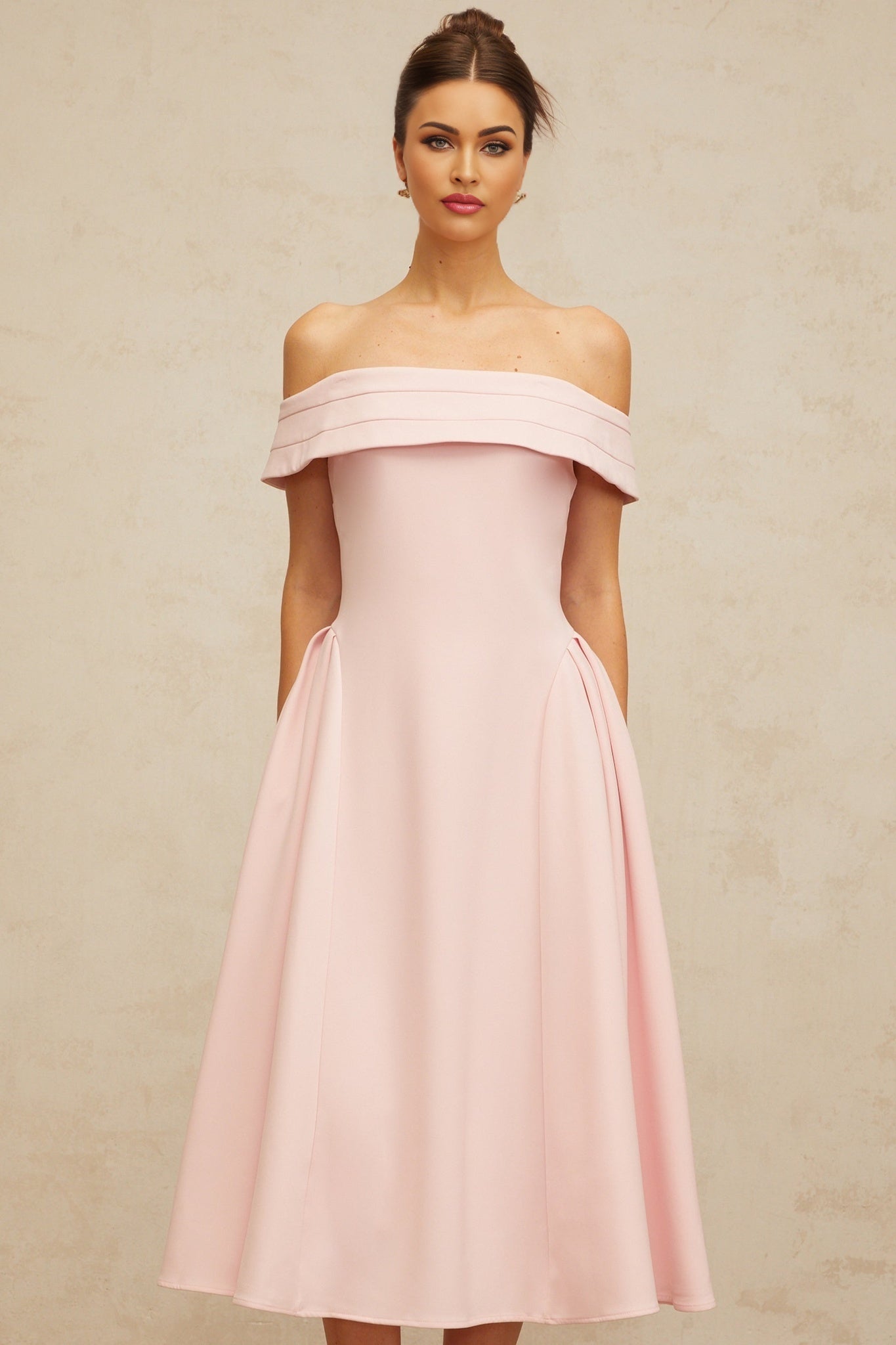 A pink offshoulder midi dress with pleated details featuring a fitted bodice and flowy skirt