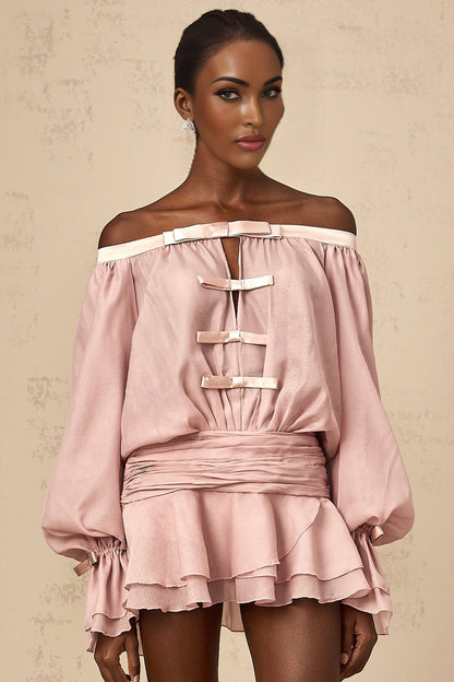 A pink offshoulder mini dress with a bow detail and flounced design worn by a model