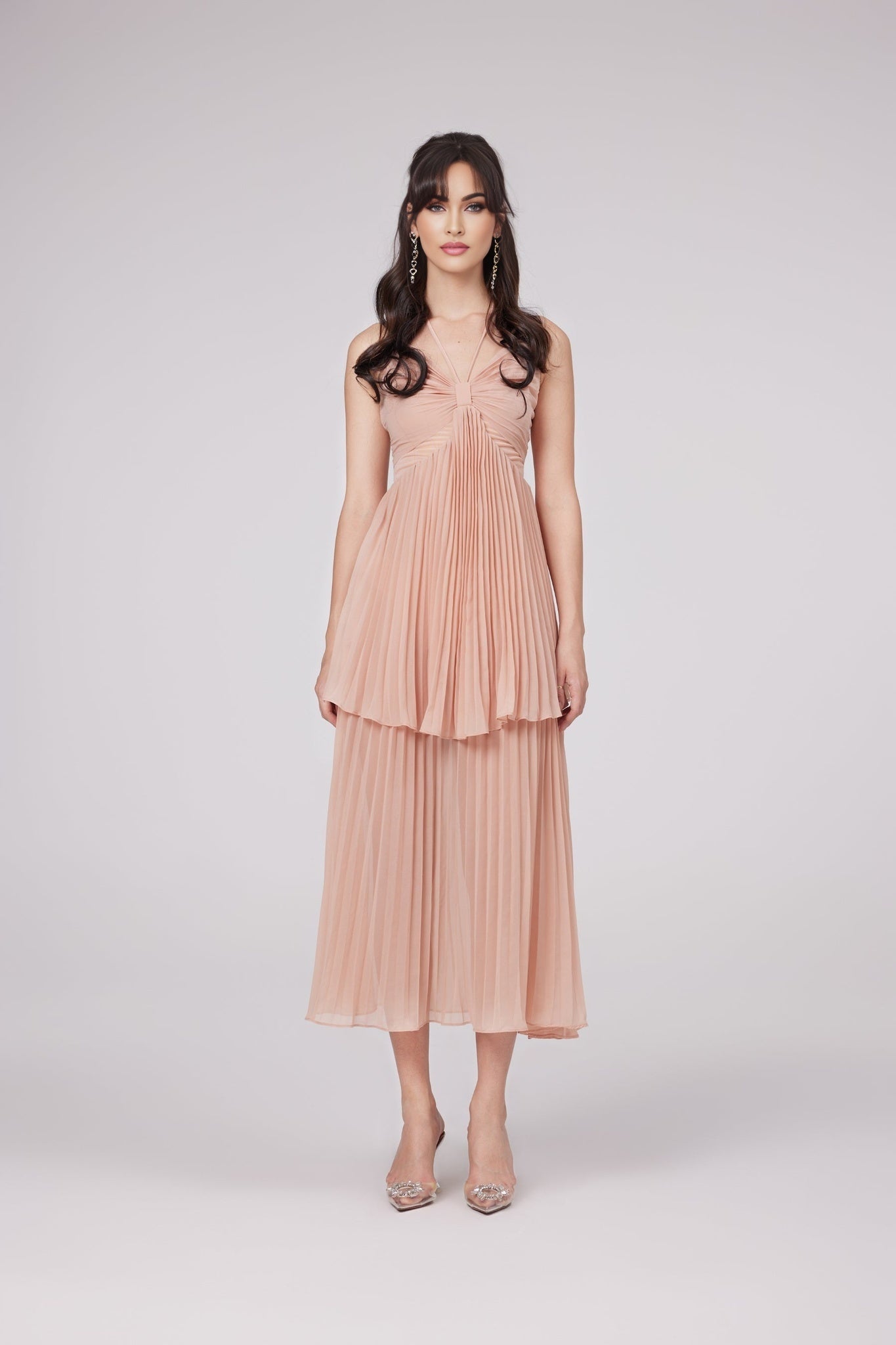 A pink pleated tiered midi dress named Olympe with a delicate and feminine design