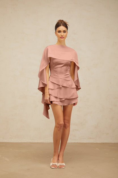 A pink satin mini dress with ruffles and a shawl panel detail called the Lyna dress