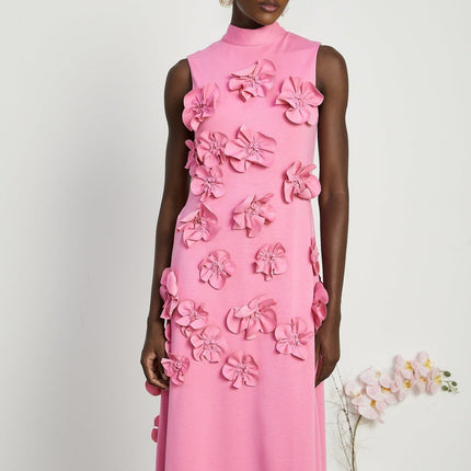 A pink sleeveless maxi dress with a bow and decorative artificial flowers named Magali
