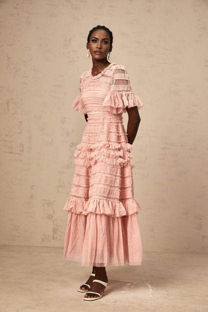A pink tulle midi dress with ruffles and small dot details named Aimee