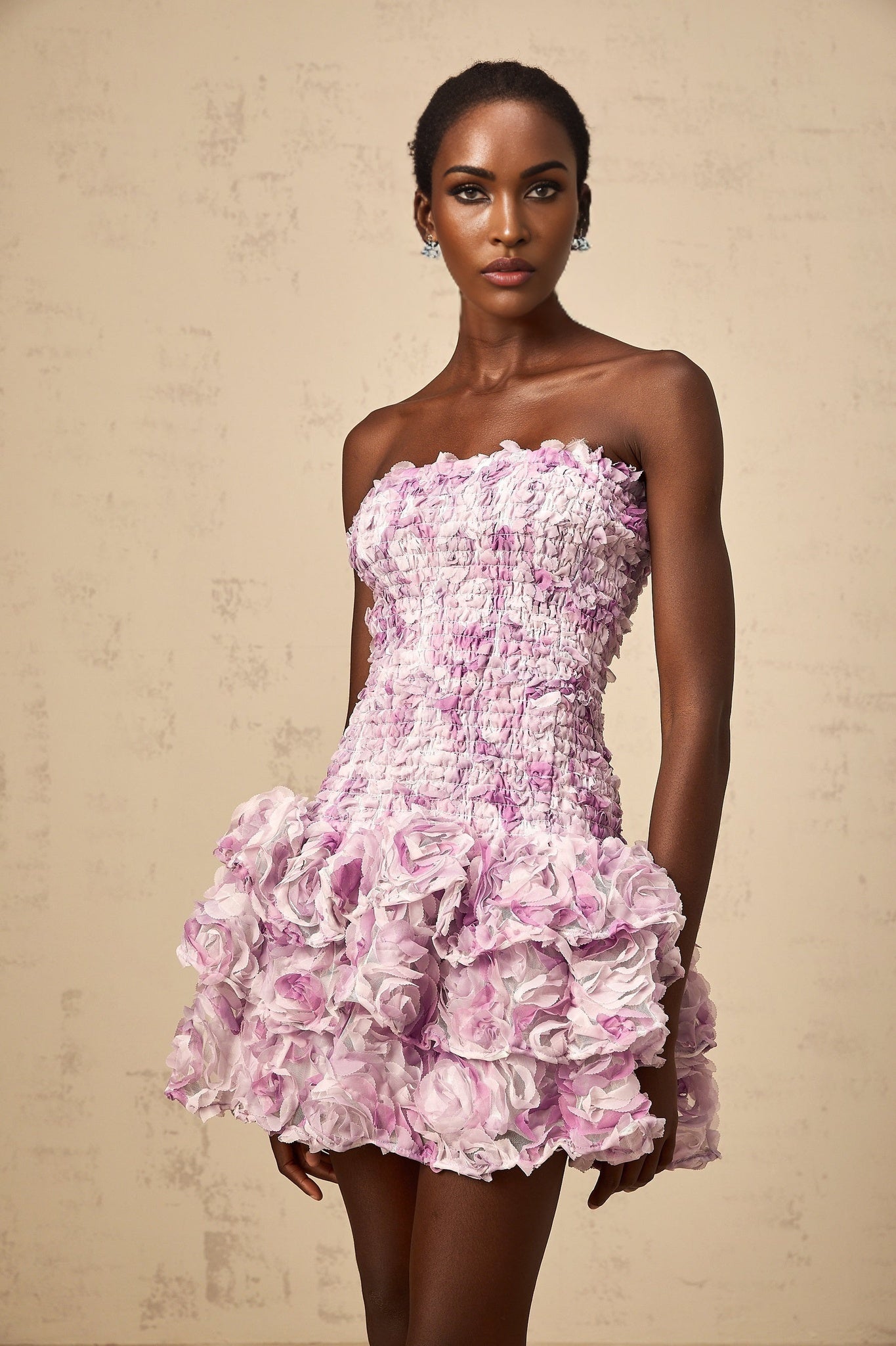 A purple mini dress with tiered tulle skirt featuring three dimensional petal details throughout