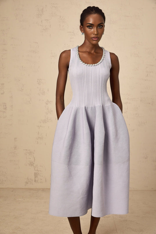 A purple ribbed knit midi dress with embellishments and a form fitting silhouette