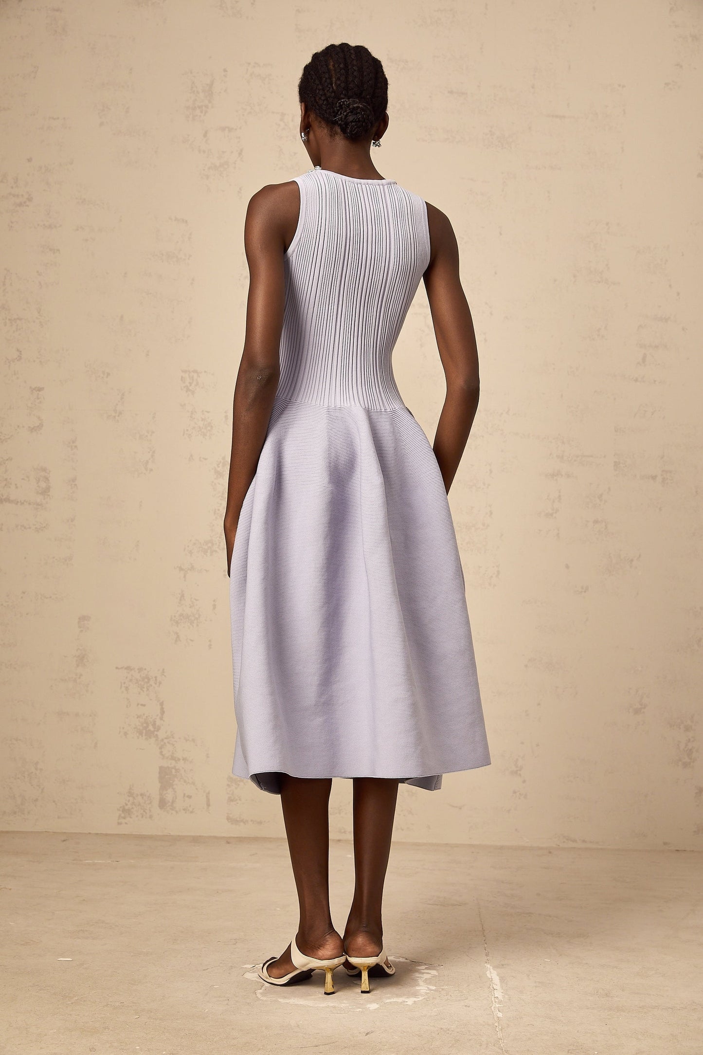 A purple ribbed knit midi dress with embellishments featuring a fitted silhouette and long sleeves