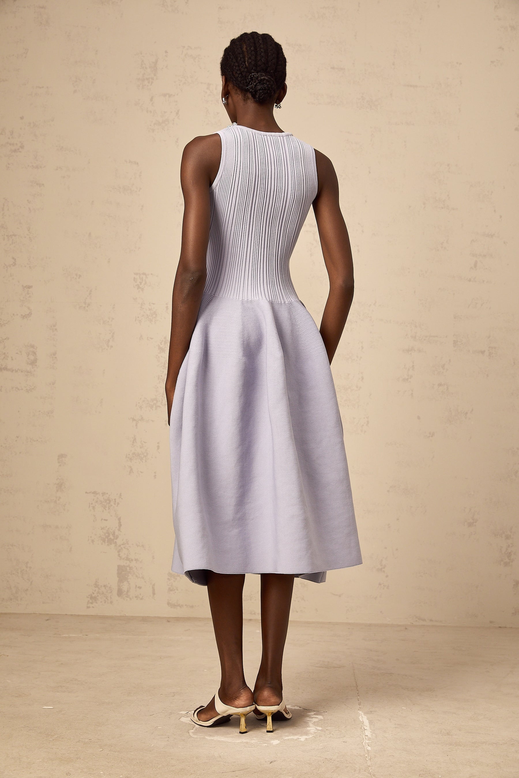 A purple ribbed knit midi dress with embellishments featuring a fitted silhouette and long sleeves