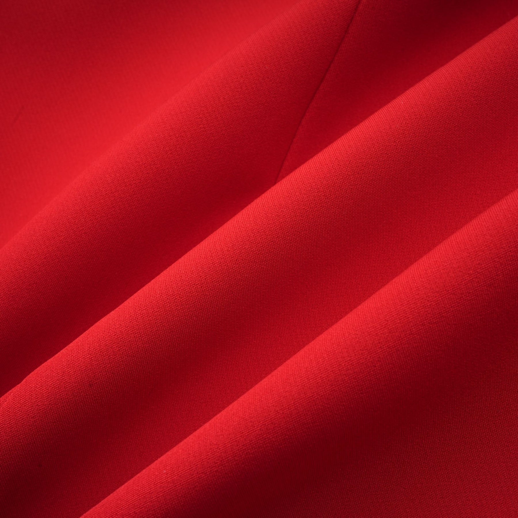A red blazer with an hourglass silhouette featuring double breasted buttons and a tailored fit