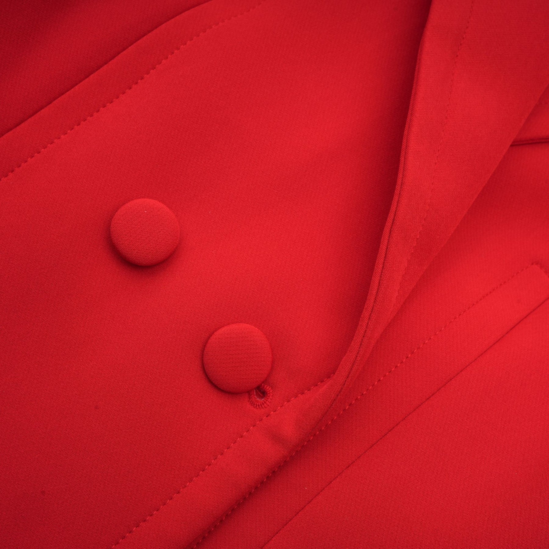 A red blazer with hourglass silhouette and doublebreasted front closure