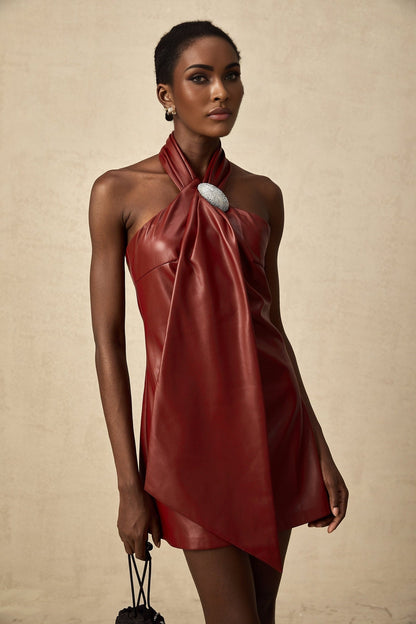 A red halterneck mini dress made of sheepskin with a sleek and formfitting silhouette
