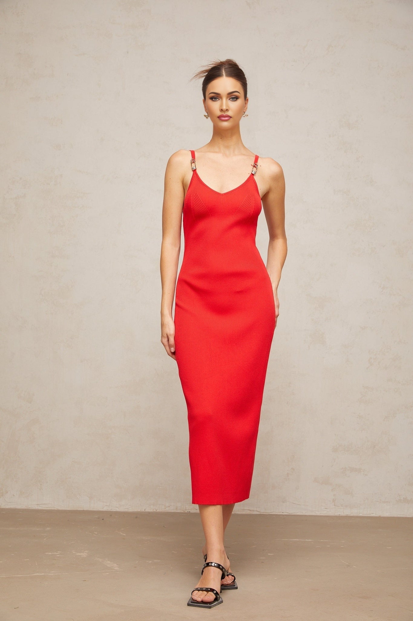 A red knitted midi dress with pin details and a fitted silhouette named Prunelle