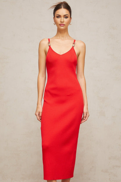 A red knitted midi dress with pin details featuring a fitted silhouette and long sleeves