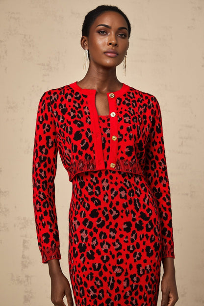 A red leopard print cardigan with a shimmery lurex fabric blend worn open over a dark top
