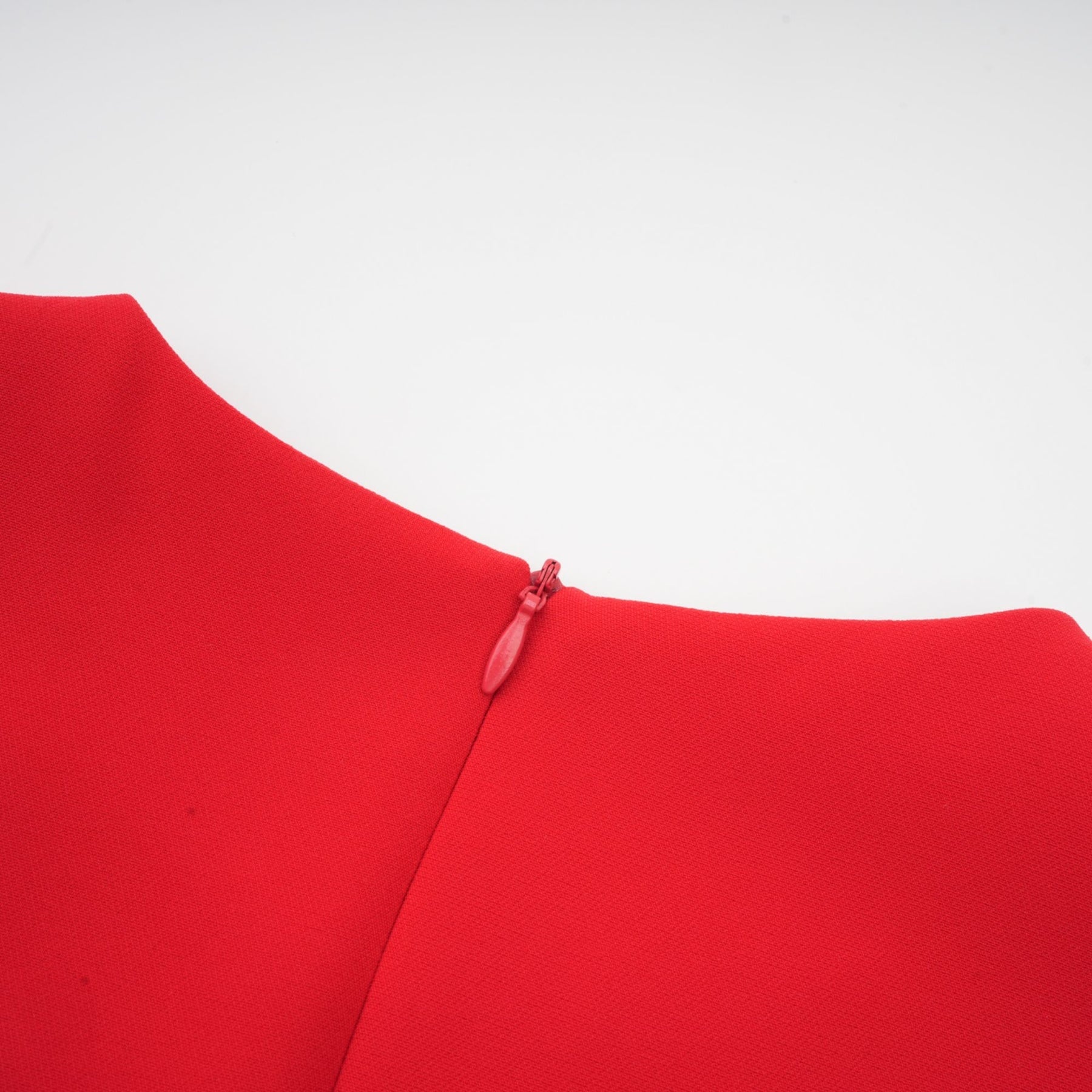A red long sleeve dress with floral embellishments by Aurelia
