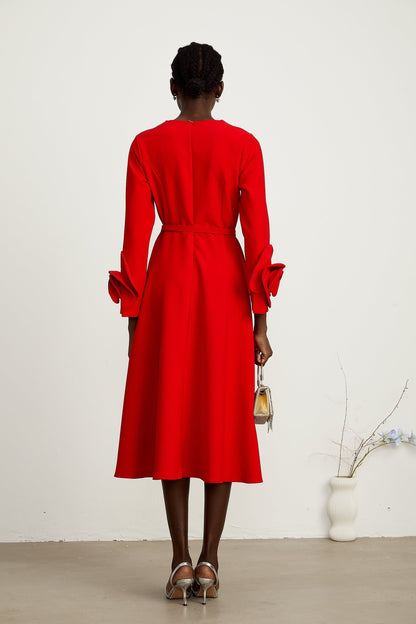 A red long sleeve dress with floral embellishments from the brand Aurelia