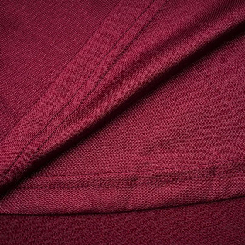 A red midi dress with a flap design and ruched detailing named Camille featuring a fitted silhouette and midlength hemline