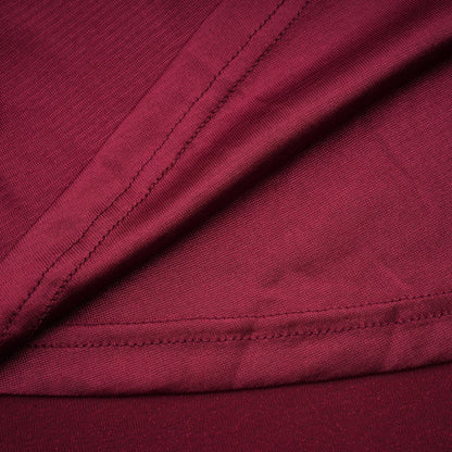 A red midi dress with a flap design and ruched detailing named Camille featuring a fitted silhouette and midlength hemline
