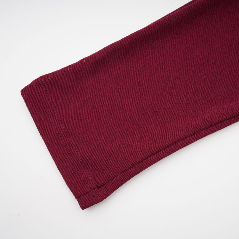 A red midi dress with a flap design and ruched detailing named Camille