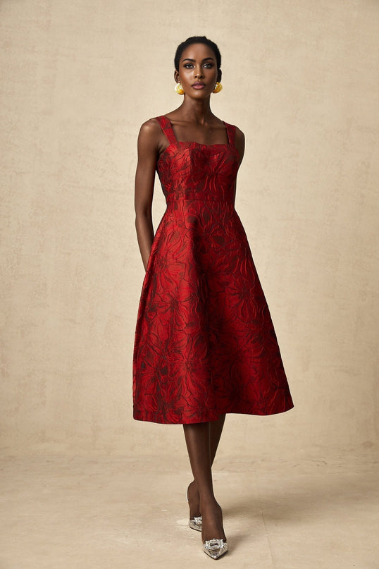 A red midi dress with a floral jacquard pattern featuring a fitted waist and flared skirt