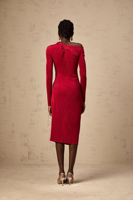 A red midi dress with a high slit and gathered fabric detailing named Monica