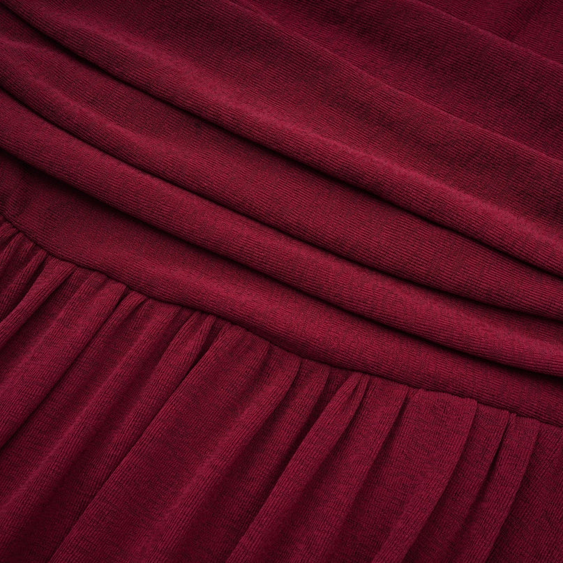 A red midi dress with ruched detailing and a flap design named Camille