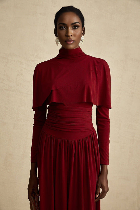 A red midi dress with ruched detailing and a flap design named Camille