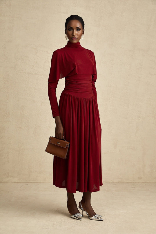 A red midi dress with ruched detailing and a flap design named Camille