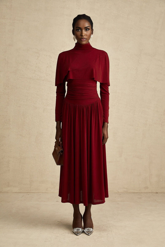 A red midi dress with ruched detailing and a flap design named Camille
