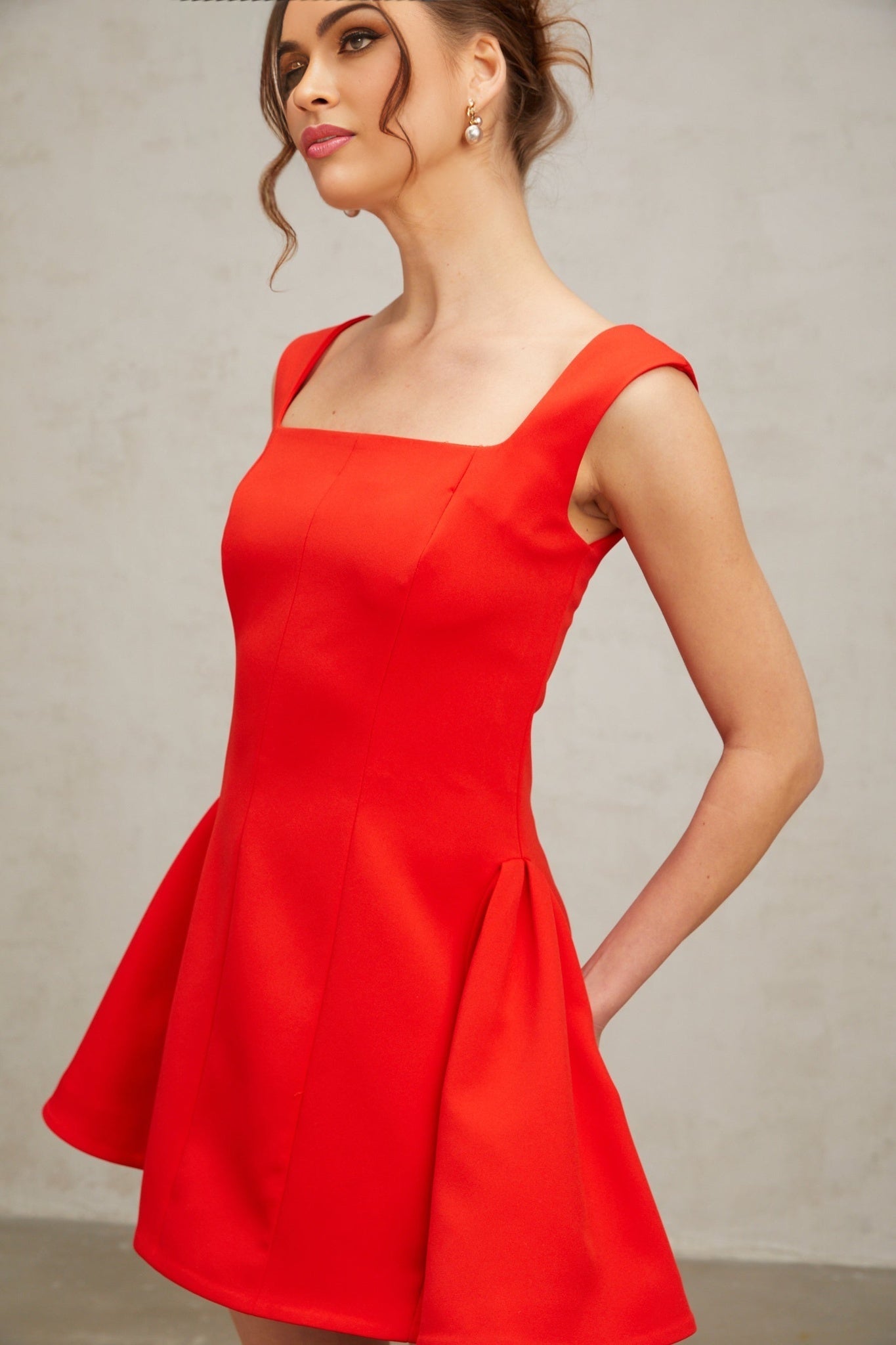 A red mini dress with a square neckline and puff sleeves in a Margherita style