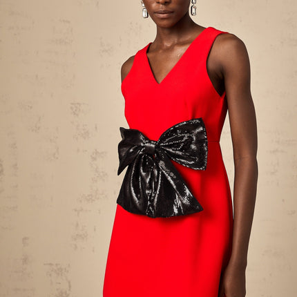 A red mini dress with a Vneckline featuring a sequin bow detail