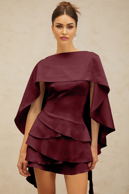 A red satin mini dress with ruffled details and a shawl panel featuring a flowy silhouette and short length